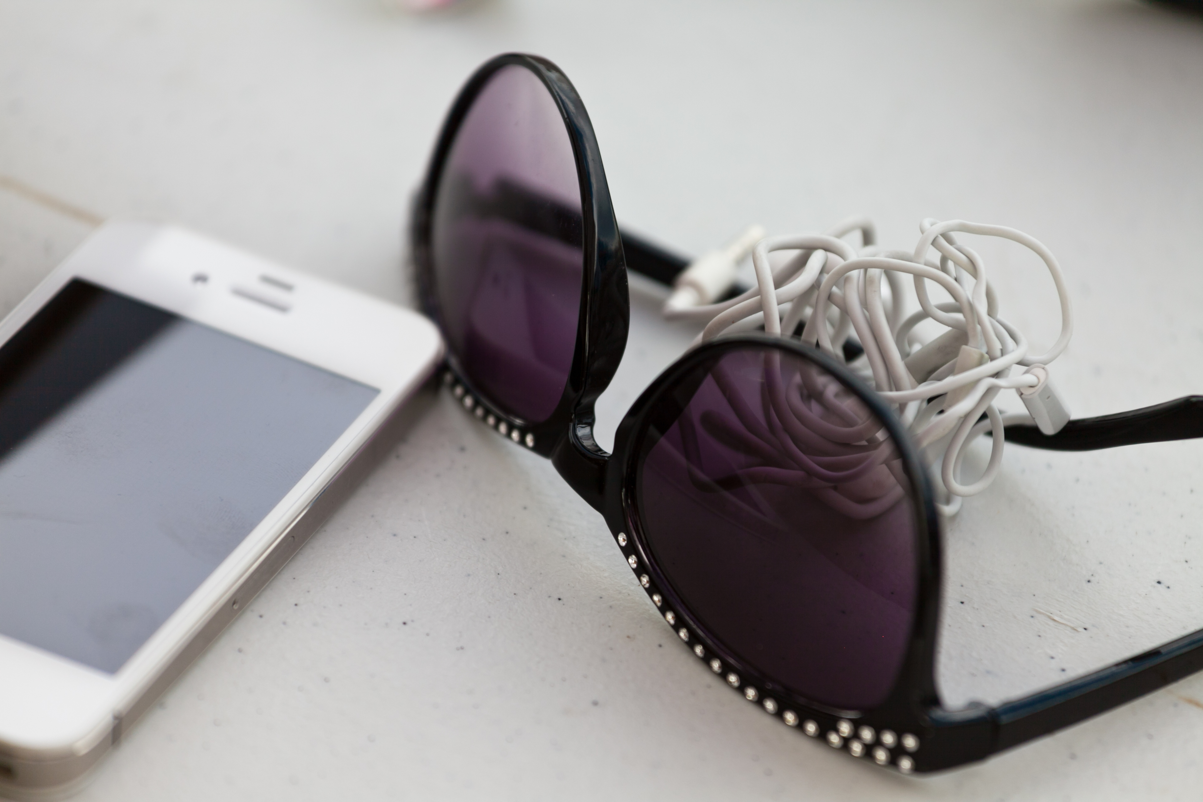 Headphones, sunglasses and a phone