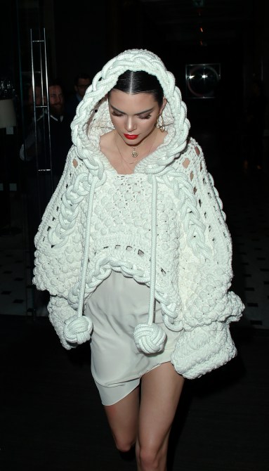 Kendall Jenner Style: Kendall wearing a crochet, hooded sweater with ball tassels and shorts at London Fashion Week in 2017.