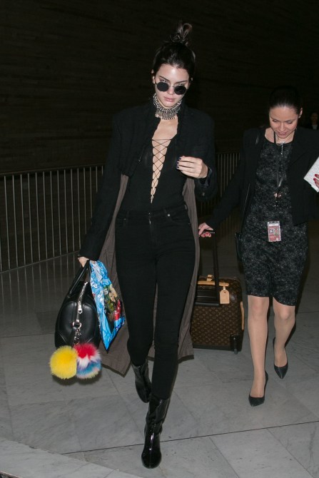Kendall Jenner Style: Kendall wearing an all-black ensemble, including a deep cut top in 2016.