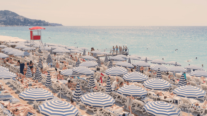 striped umbrellas in Nice on beach