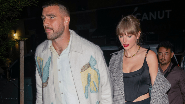 Photo of Travis Kelce walking and holding hands with Taylor Swift during a date. 