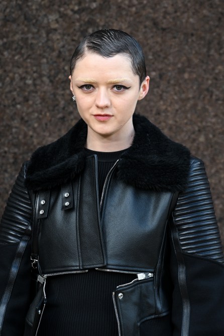 Maisie Williams with a short buzzcut and bleached brows.