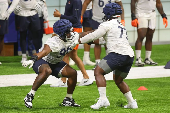 Zacch Pickens #96 and 
Travis Bell #73 of the Chicago Bears take part in a drill during training camp at Halas Hall on July 26, 2023 in Lake Forest, Illinois.