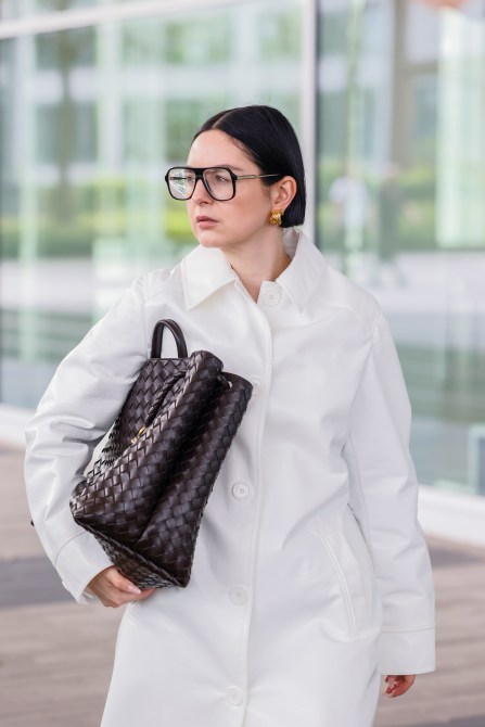 An influencer wearing black aviator glasses.