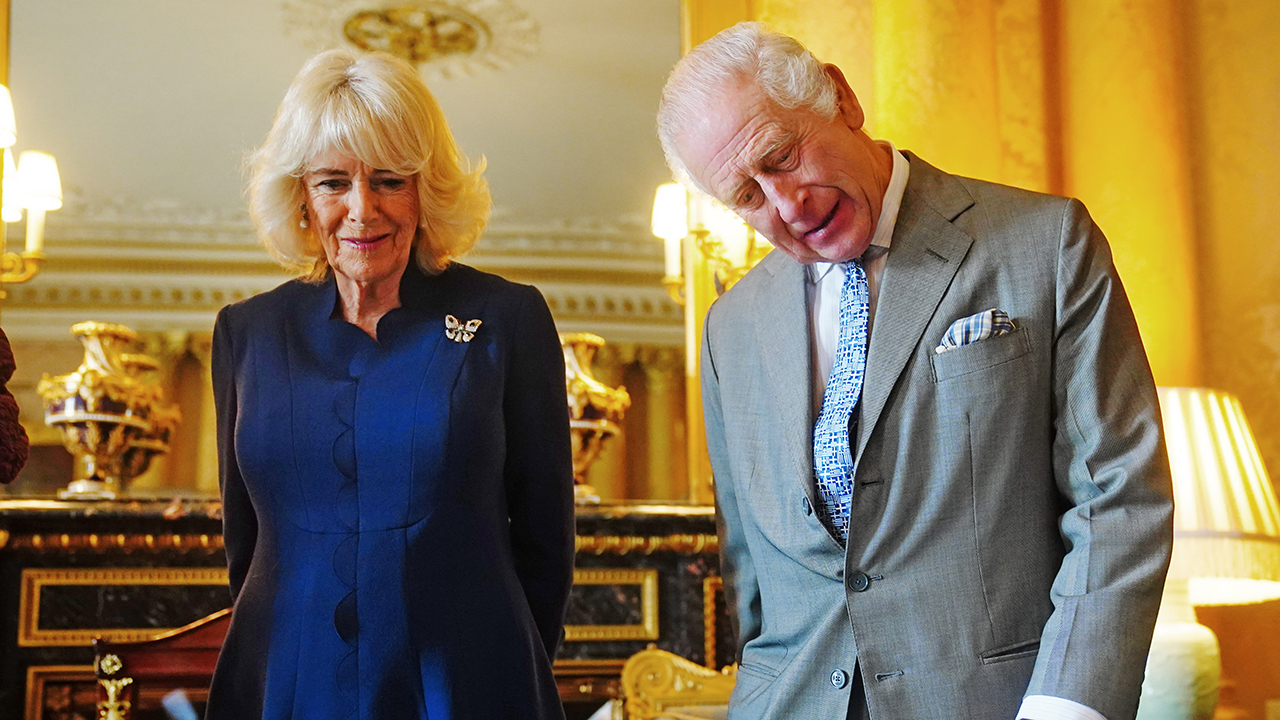 King Charles III and Queen Camilla are presented with the Coronation Roll, an official record of their Coronation at Buckingham Palace on May 1, 2024 in London, England.