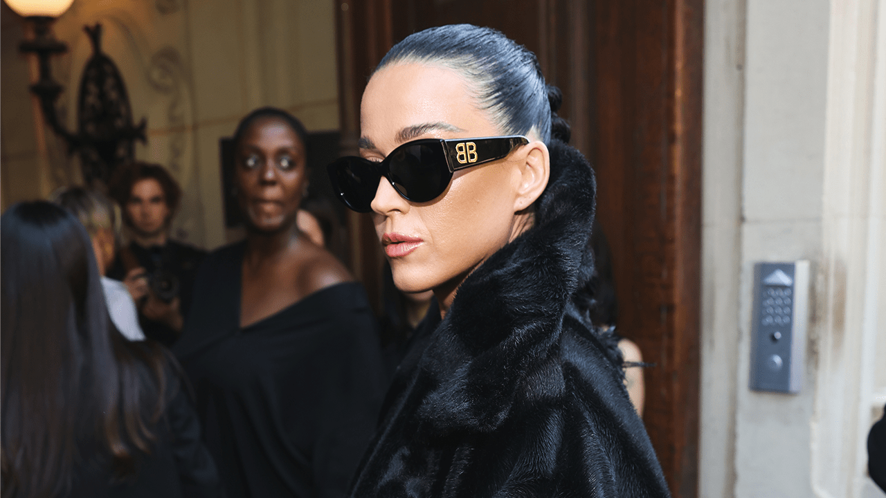 Katy Perry wearing a fur coat and sunglasses.