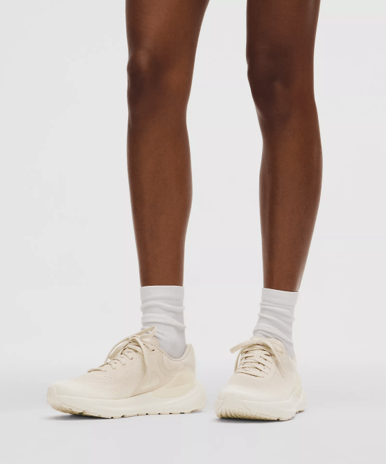 A model wearing the Lululemon Beyondfeel Running Shoe in ivory