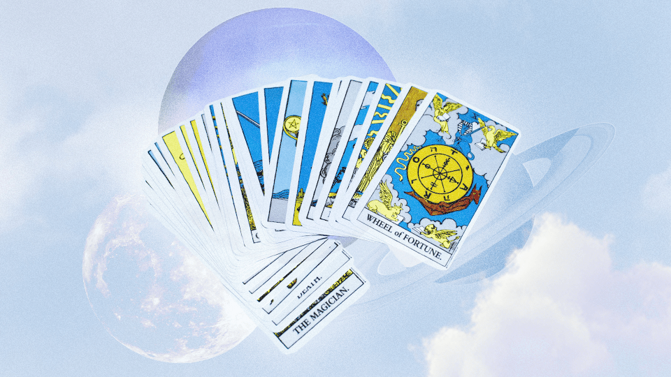 A spread of Tarot cards in front of an indigo blue space background