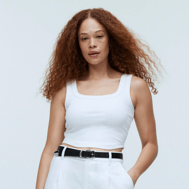 A model wearing a white tank top from Madewell