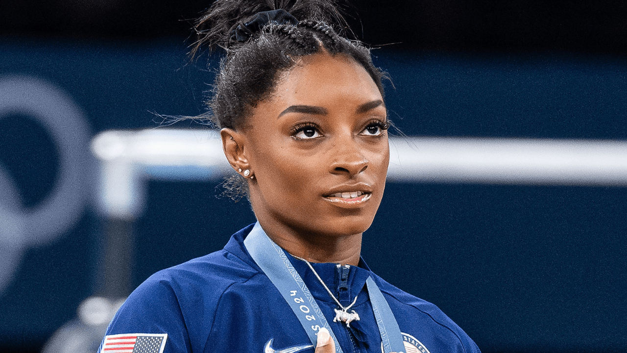 Gold medalist and winner Simone Biles of USA looks on during the national anthem with her gold medal while the women´s final all-round competition on day six of the Olympic Games Paris 2024 at Bercy Arena on August 01, 2024 in Paris, France.