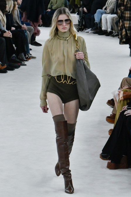A Chloe runway show model wearing a suede bag