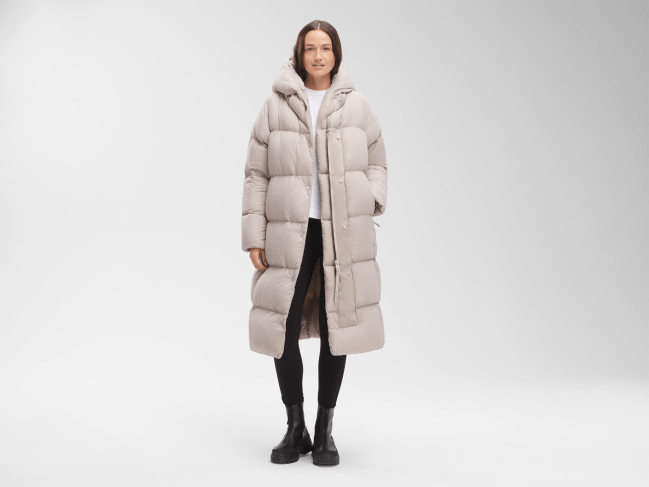 A model wearing the Canada Goose Rhoda Parka in Limestone color