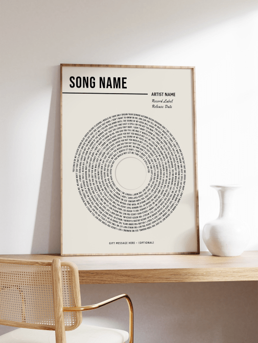 TheWorldGallery Custom Vinyl Lyrics Print sitting on top of a table or desk next to a white vase