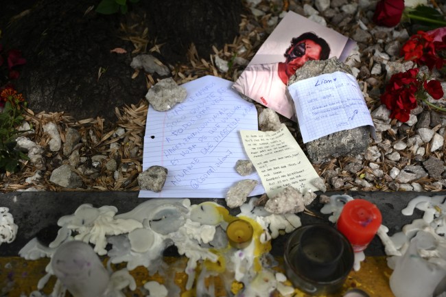 Letters and candles left by a fans honoring British singer Liam Payne are seen in front of the hotel where he died in Buenos Aires on October 17, 2024. Tributes poured in Thursday for British singer Liam Payne, a former member of the best-selling boy band One Direction, after he plunged to his death from the balcony of a Buenos Aires hotel.