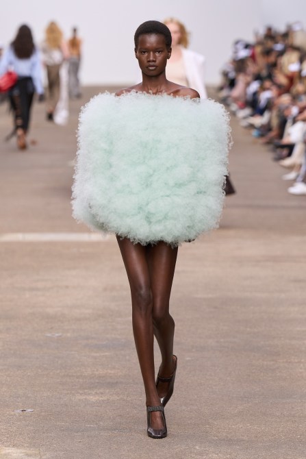 A model wearing a seafoam green dress.