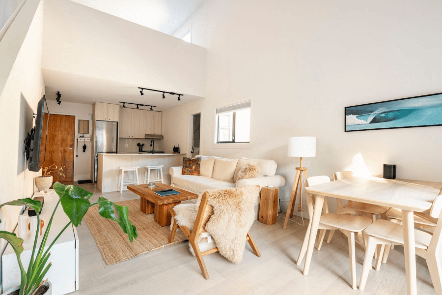 A bright living room with a dining area and kitchen on each side. A Kitsilano, Vancouver Airbnb.