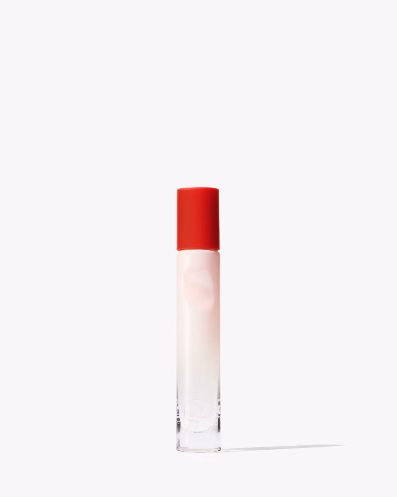 Glossier You Rollerball in a pink and red bottle.