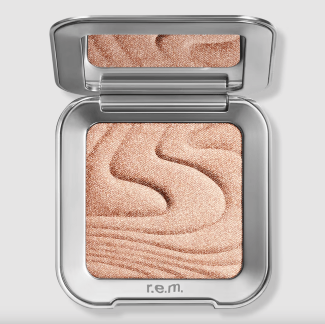 R.e.m. beauty Interstellar Highlighter Topper in a silver compact.