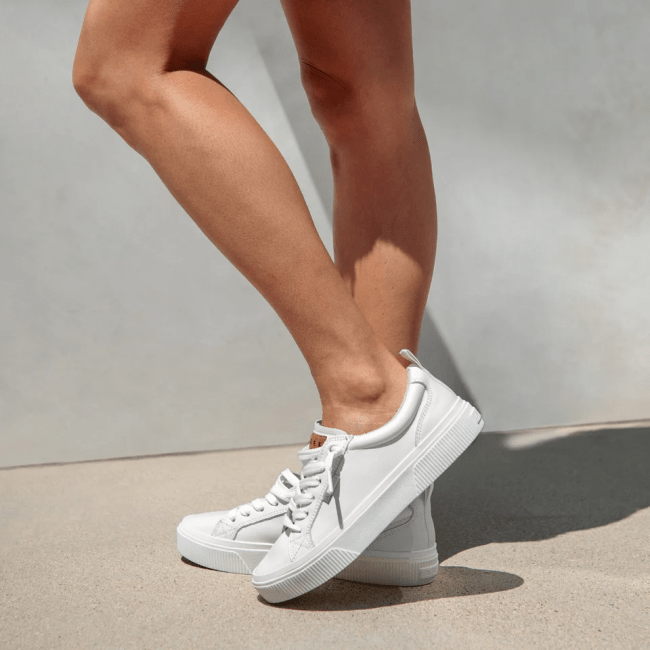 A model wearing the Reef Lay Day Dawn sneakers in white