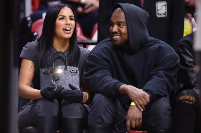 MIAMI, FLORIDA - MARCH 12: Rapper Kanye West and girlfriend Chaney Jones attend a game between the Miami Heat and the Minnesota Timberwolves at FTX Arena on March 12, 2022 in Miami, Florida. NOTE TO USER: User expressly acknowledges and agrees that, by downloading and or using this photograph, User is consenting to the terms and conditions of the Getty Images License Agreement.