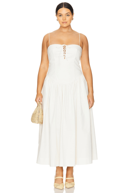 A model wearing the L'Academie by Marianna Thierry Midi Dress in white