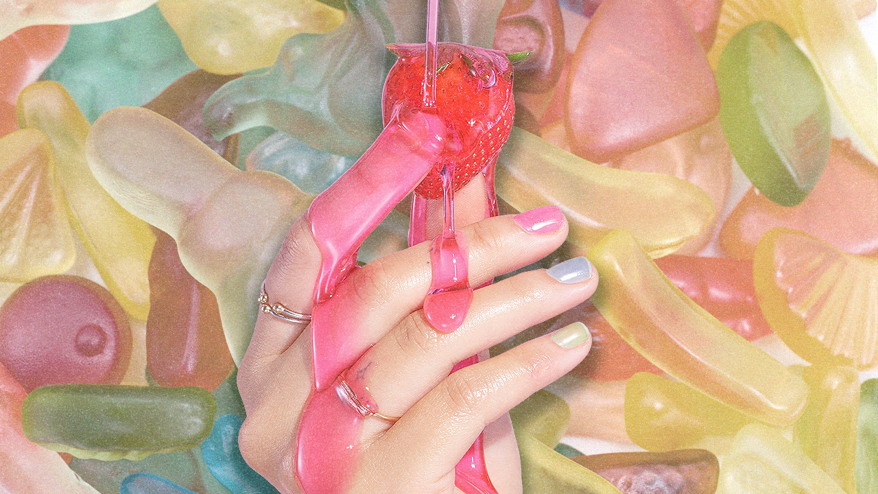A model wearing jelly nails with gummy candies in the background.