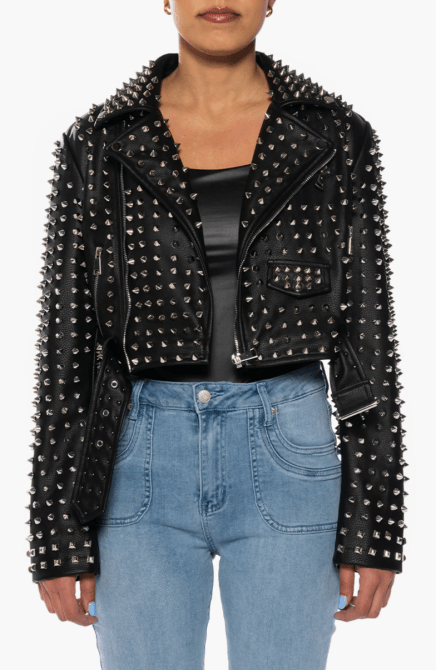 A model wearing the Azalea Wang Studded Belted Faux Leather Moto Jacket in black