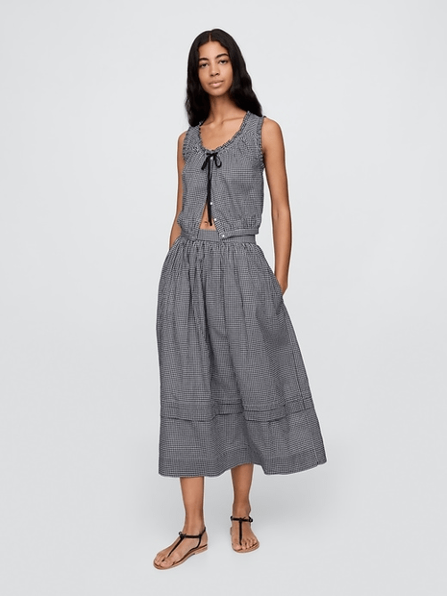 A model wearing the Gap x Dôen Gingham Maxi Skirt with the matching top in a navy gingham print