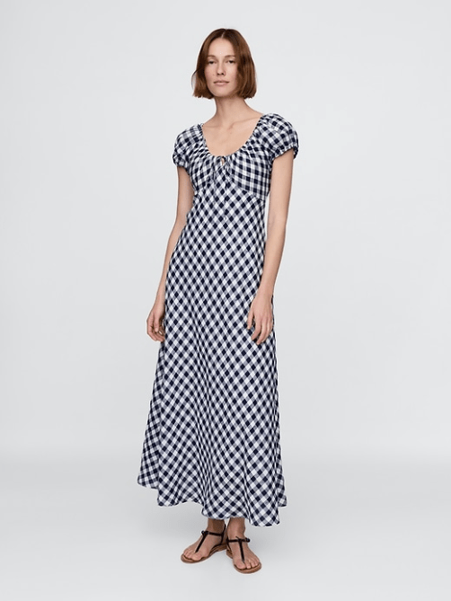 A model wearing the Gap x Dôen 100% Linen Gingham Maxi Dress in a navy blue gingham print