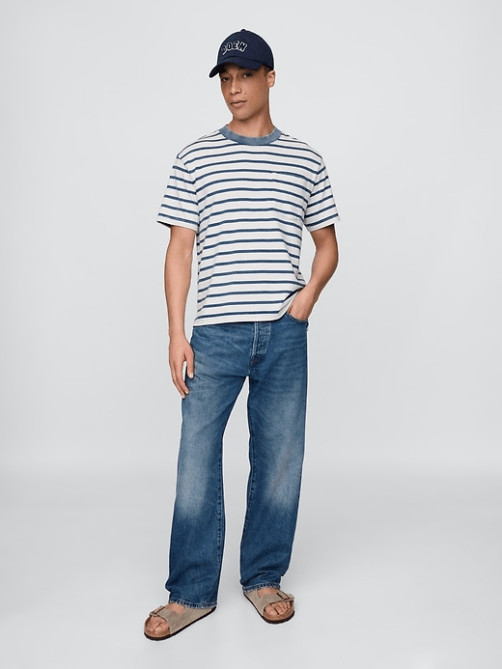 A model wearing the Gap x Dôeen Pocket T-Shirt and a blue and off-white stripe pattern