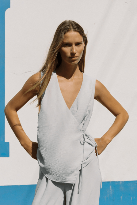 A Zara model wearing the Flowy Wrap Vest Top in a light gray colorway
