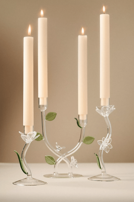 Four Ivie Floral Glass Taper Candle Holders with lit candlesticks in them