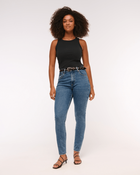A model wearing Abercrombie & Fitch's Curve Love High Rise Modern Skinny Jean in a medium wash