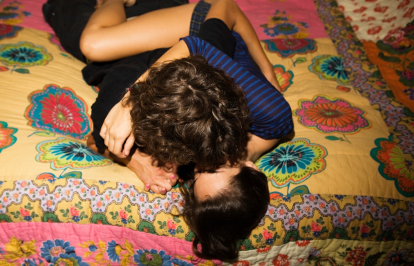 A man and woman making out in bed