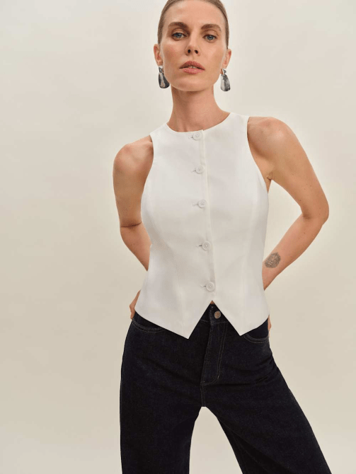 A model wearing Reformation's Rory Vest in white