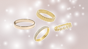 Mauve background with white sparkles and four gold wedding bands.