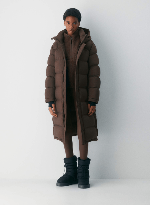 A model wearing the Aritzia The Super Puff™ Long - cliMATTE™ in Rich Mocha Brown