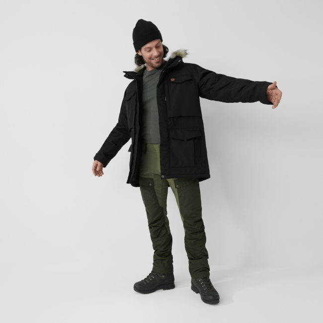 A male model wearing the Fjallraven Nuuk Parka in black