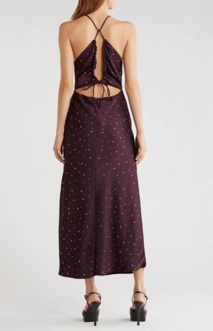 A woman in a maroon backless slip dress