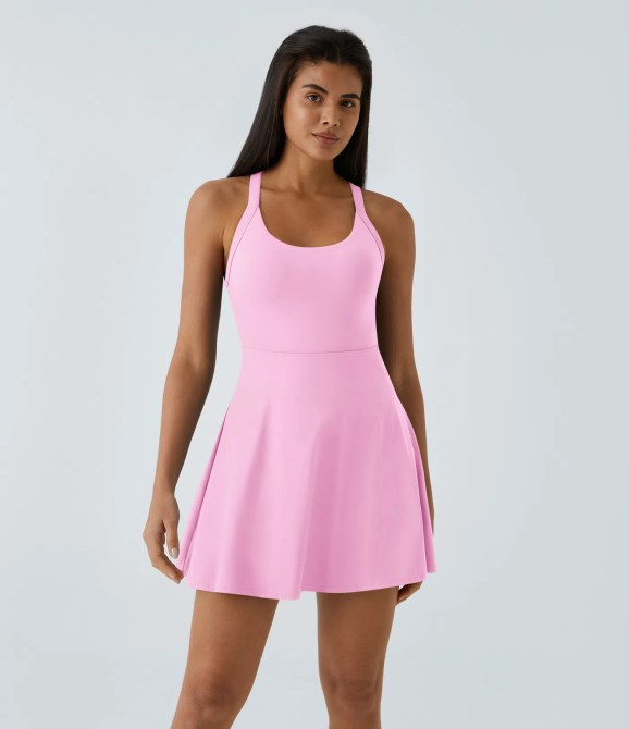 A woman wearing a pink tennis dress