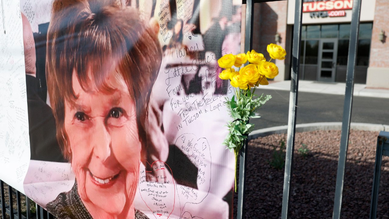 A photograph of Nancy Guthrie is displayed on a banner in front of the KVOA television station in March 2026.
