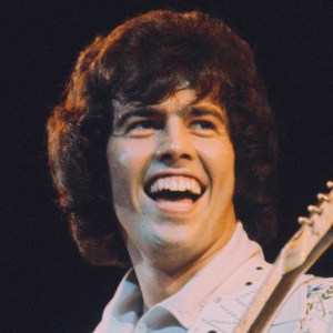 Musician and guitarist Alan Osmond performs live on stage with American family pop group The Osmonds on the British leg of their European tour, October 1973.