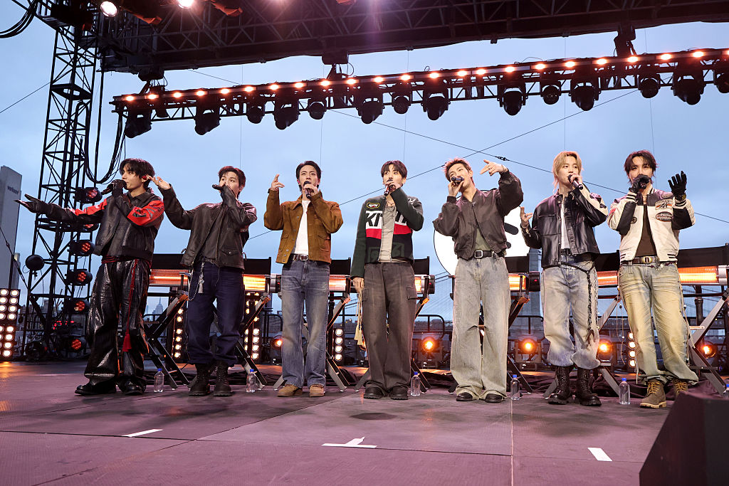 NEW YORK, NEW YORK - MARCH 23: (L-R) V, Suga, Jin, Jungkook, RM, Jimin and J-Hope of BTS speak onstage during Spotify x BTS: SWIMSIDE at Pier 17 on March 23, 2026 in New York City. (Photo by Kevin Mazur/Kevin Mazur/Getty Images for Spotify)