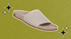 Vionic slide sandals on a green background