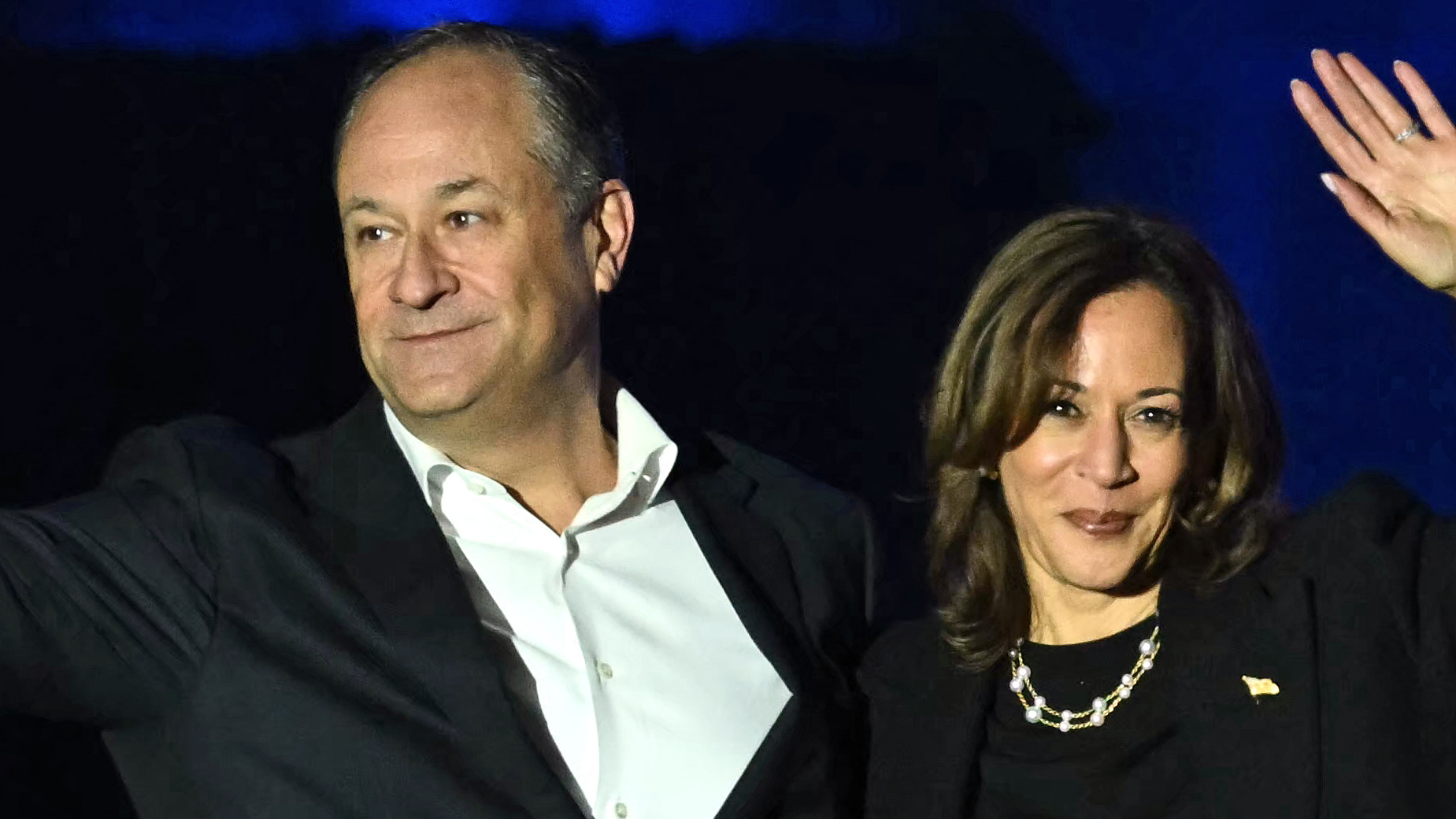 TOPSHOT - US Vice President and Democratic presidential candidate Kamala Harris and US Second Gentleman Doug Emhoff wave at supporters at the end of a campaign rally on the Benjamin Franklin Parkway in Philadelphia, Pennsylvania on November 4, 2024.