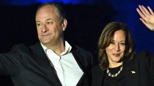 TOPSHOT - US Vice President and Democratic presidential candidate Kamala Harris and US Second Gentleman Doug Emhoff wave at supporters at the end of a campaign rally on the Benjamin Franklin Parkway in Philadelphia, Pennsylvania on November 4, 2024.