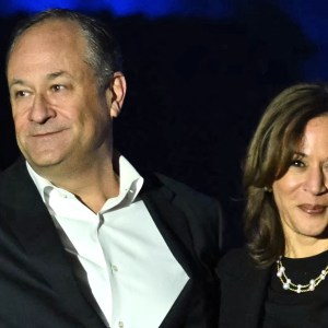 TOPSHOT - US Vice President and Democratic presidential candidate Kamala Harris and US Second Gentleman Doug Emhoff wave at supporters at the end of a campaign rally on the Benjamin Franklin Parkway in Philadelphia, Pennsylvania on November 4, 2024.